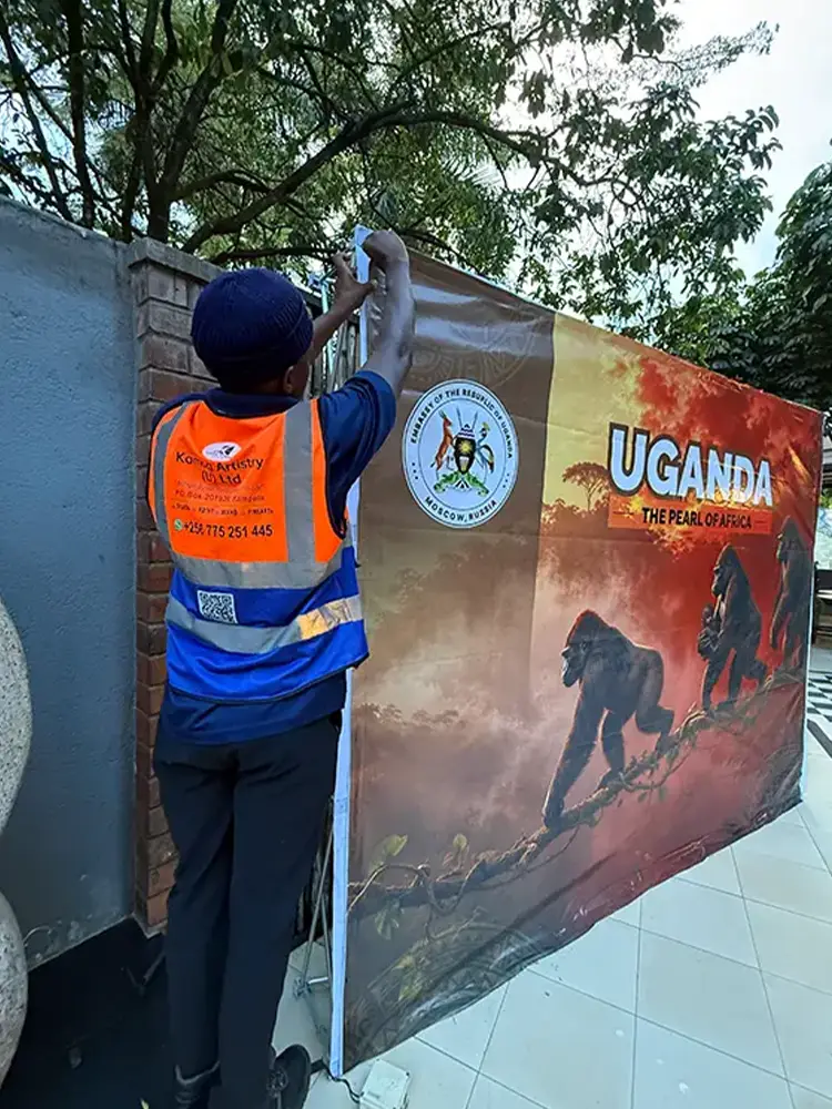 Same-day event backdrop installation in progress for the Feliz Tropical Safaris international reception in Kampala
