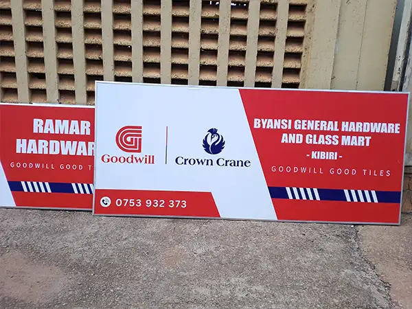 Completed Goodwill and Crown Crane framed PVC hardware signage after fabrication, stretching and aluminium finishing in Kampala for the Central Uganda rollout
