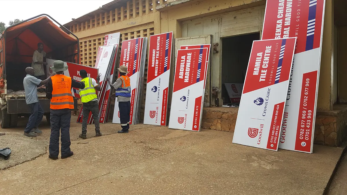 Kamog Artistry team loading completed Goodwill framed signs for route deployment