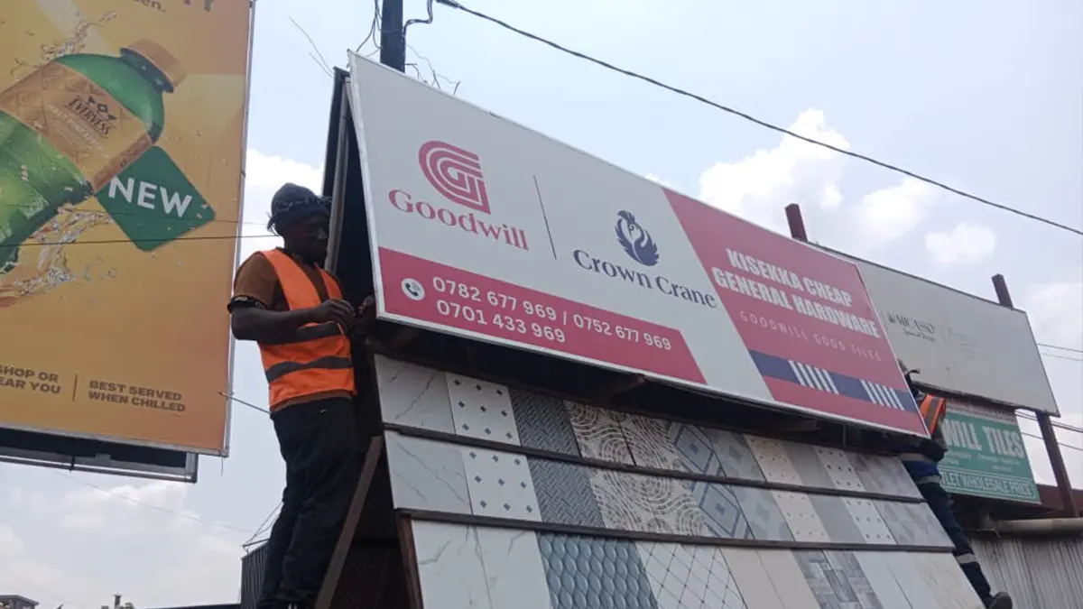 Opposing-direction Crown Crane signage mounted for two-way visibility at Kisekka Cheap General Hardware • Kansanga for the Goodwill and Crown Crane rollout