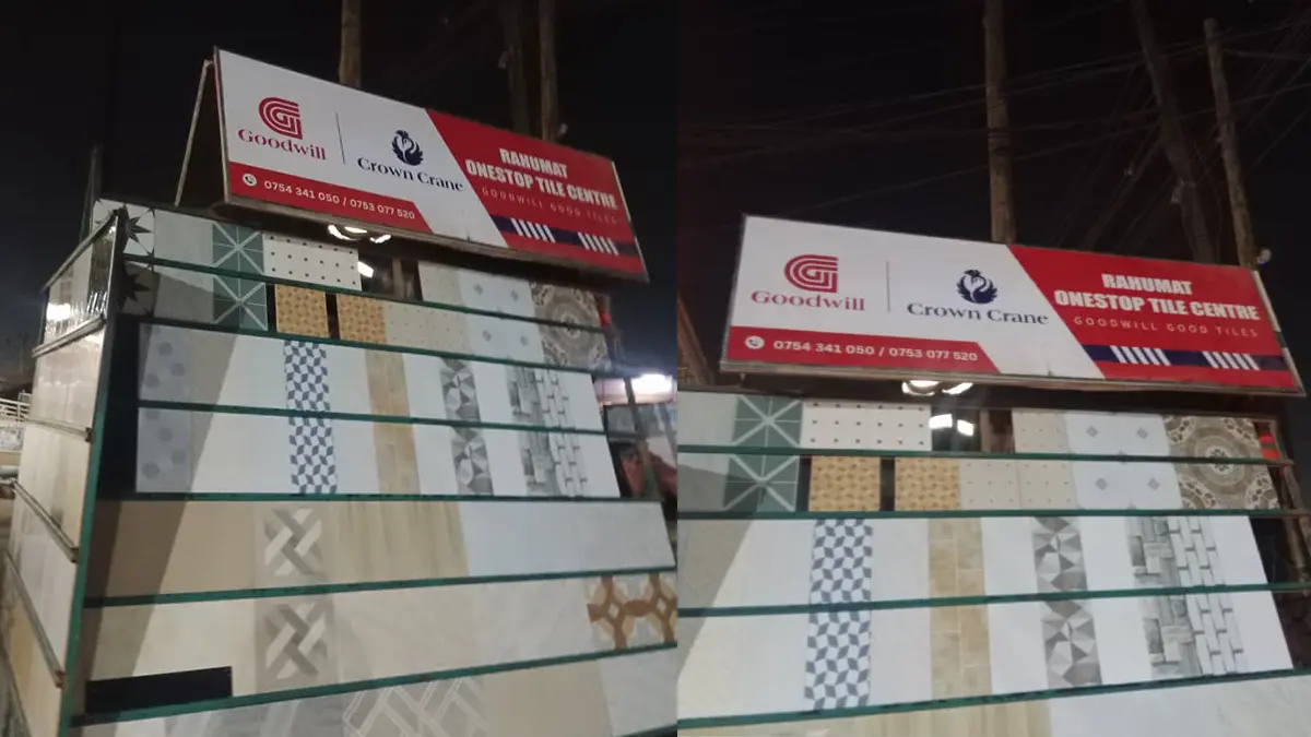 Two opposing-direction signs installed at night at Rahumat • Nalukolongo for the Goodwill and Crown Crane rollout