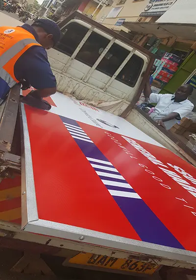 Completed Goodwill framed PVC hardware-front sign on a pickup during loading for delivery