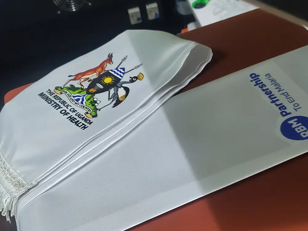 Transfer preparation for scarf branding from RBM Partnership to End Malaria event branding case study by Kamog Artistry (U) Ltd