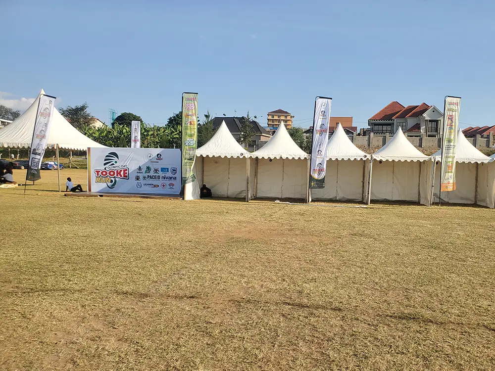 Tooke Run 2026 teardrop banners lining event tents and photo backdrop area
