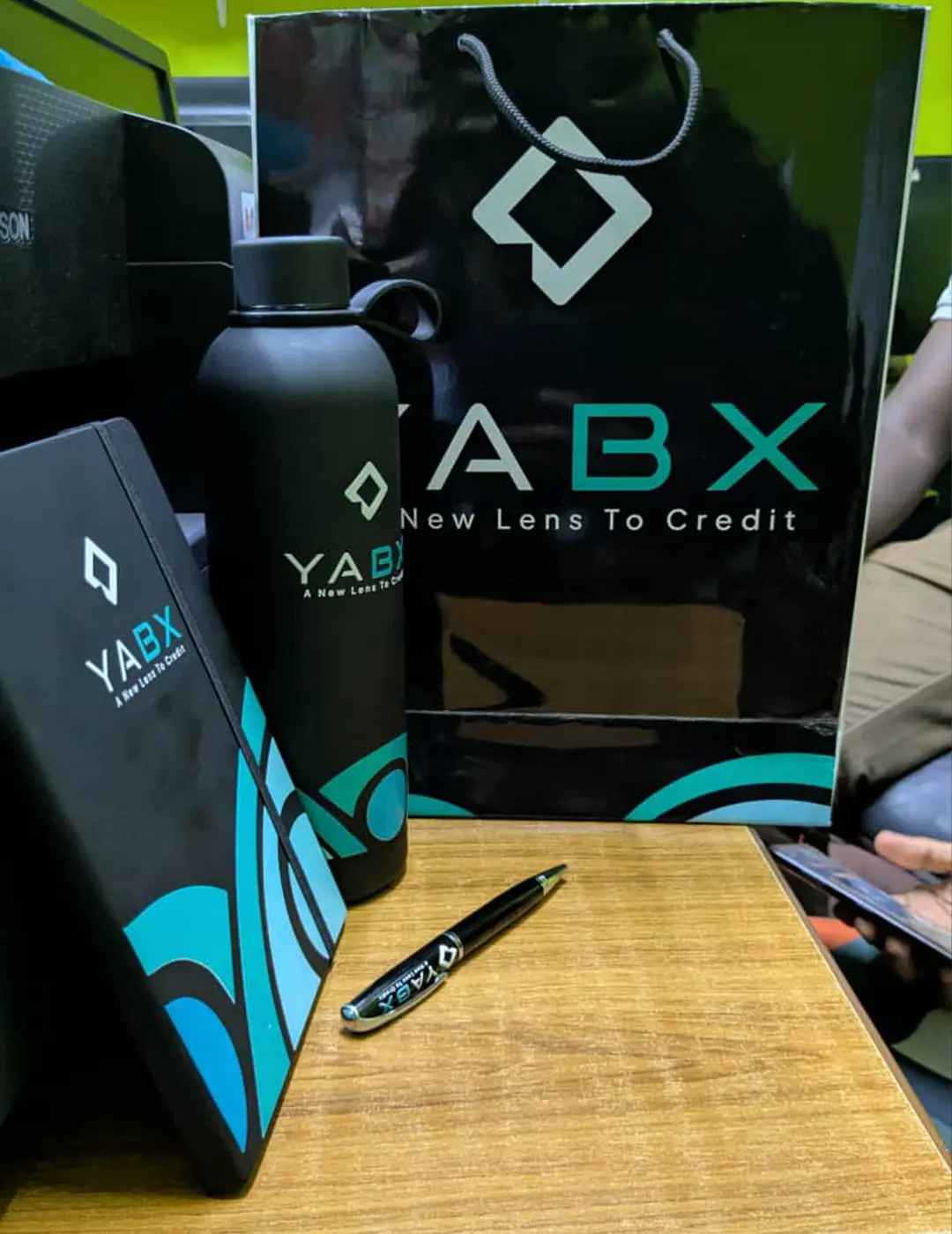 YABX corporate Christmas gift package with branded notebook, bottle, pen, card and gift bag by Kamog Artistry