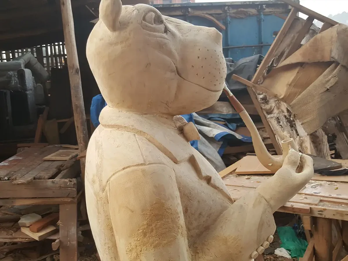 Side view of Bobby Otto Gentleman Hippo sculpture showing pipe detail