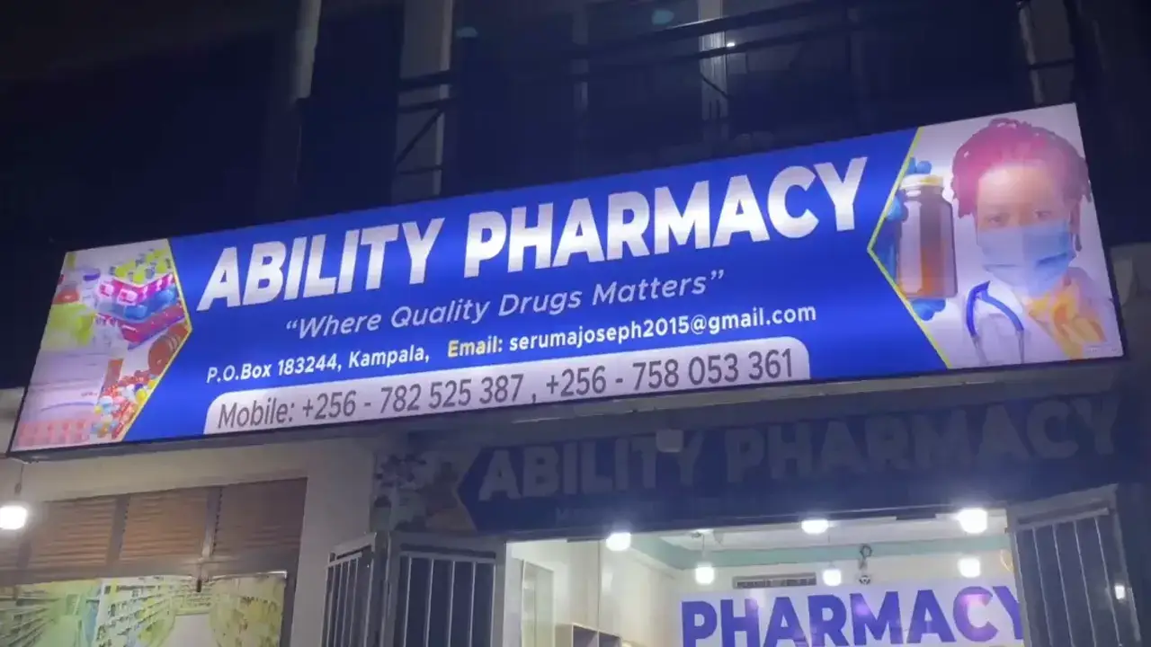 Night shot of an illuminated outdoor lightbox sign showing brand rollout and signage visibility for a Kampala business